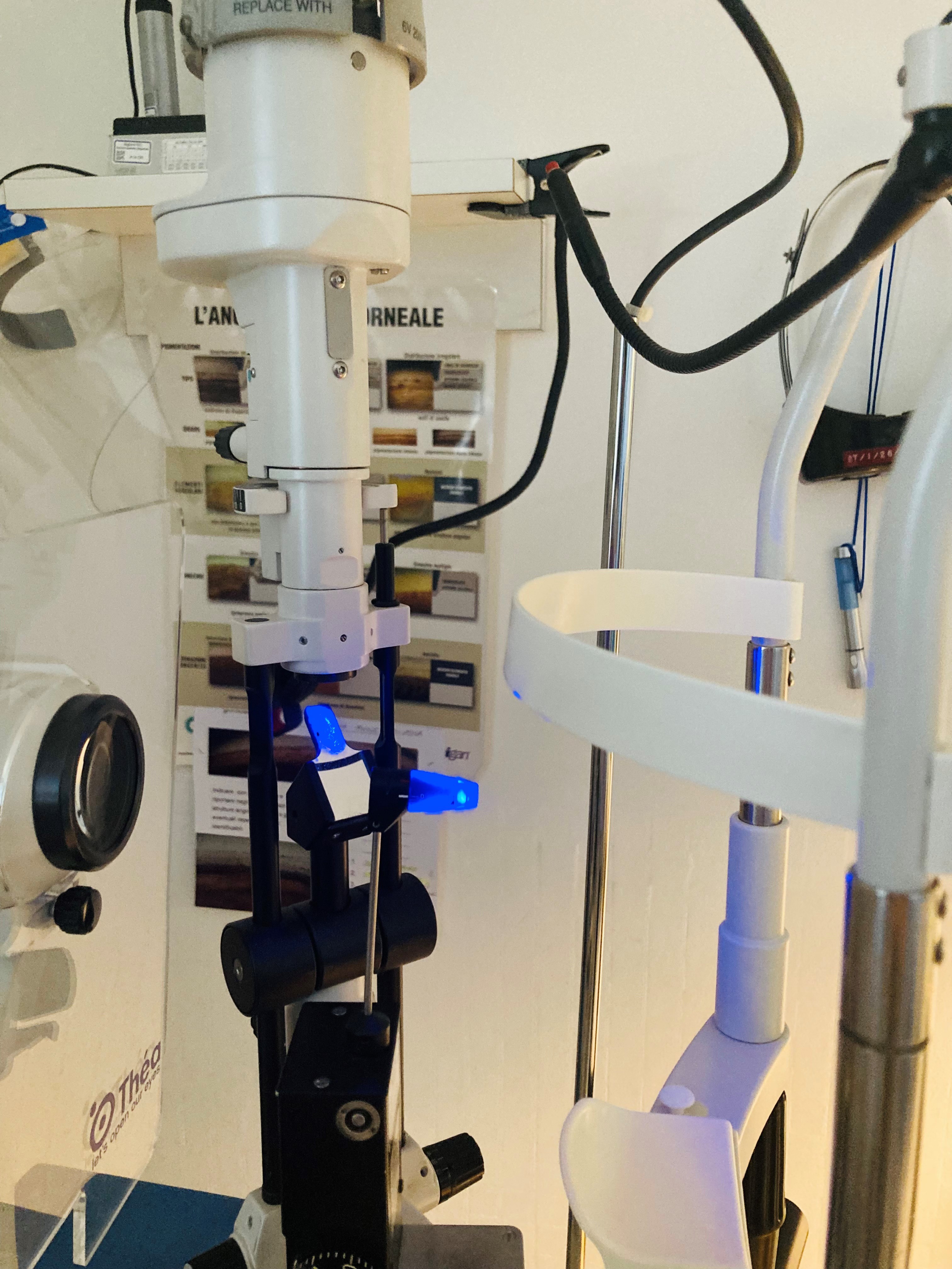 Goldmann Applanation Tonometer (GAT) mounted on a slit-lamp.